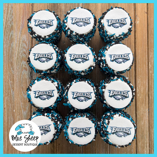 Custom cupcakes decorated with the Philadelphia Eagles football team logo, in team colors, ready for a birthday celebration.