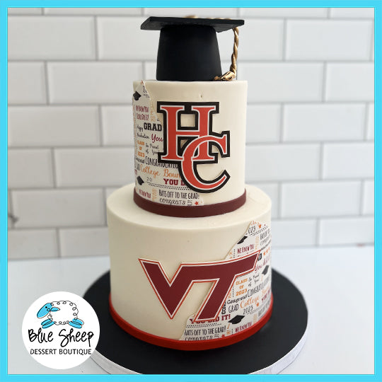 A two-tiered graduation cake with Hunterdon Central and Virginia Tech logos, topped with a black graduation cap and a diploma.