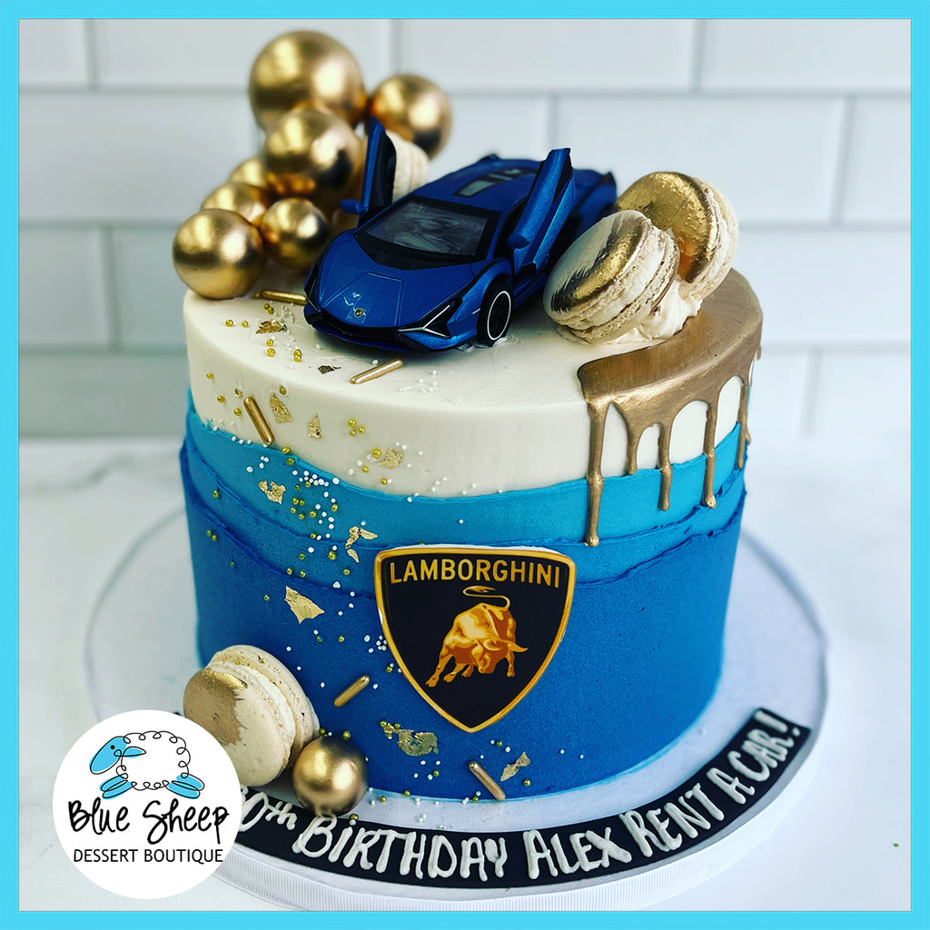 "Custom birthday cake with a luxurious blue sports car topper, gold and silver edible accents, and themed decorations, perfect for a birthday celebration