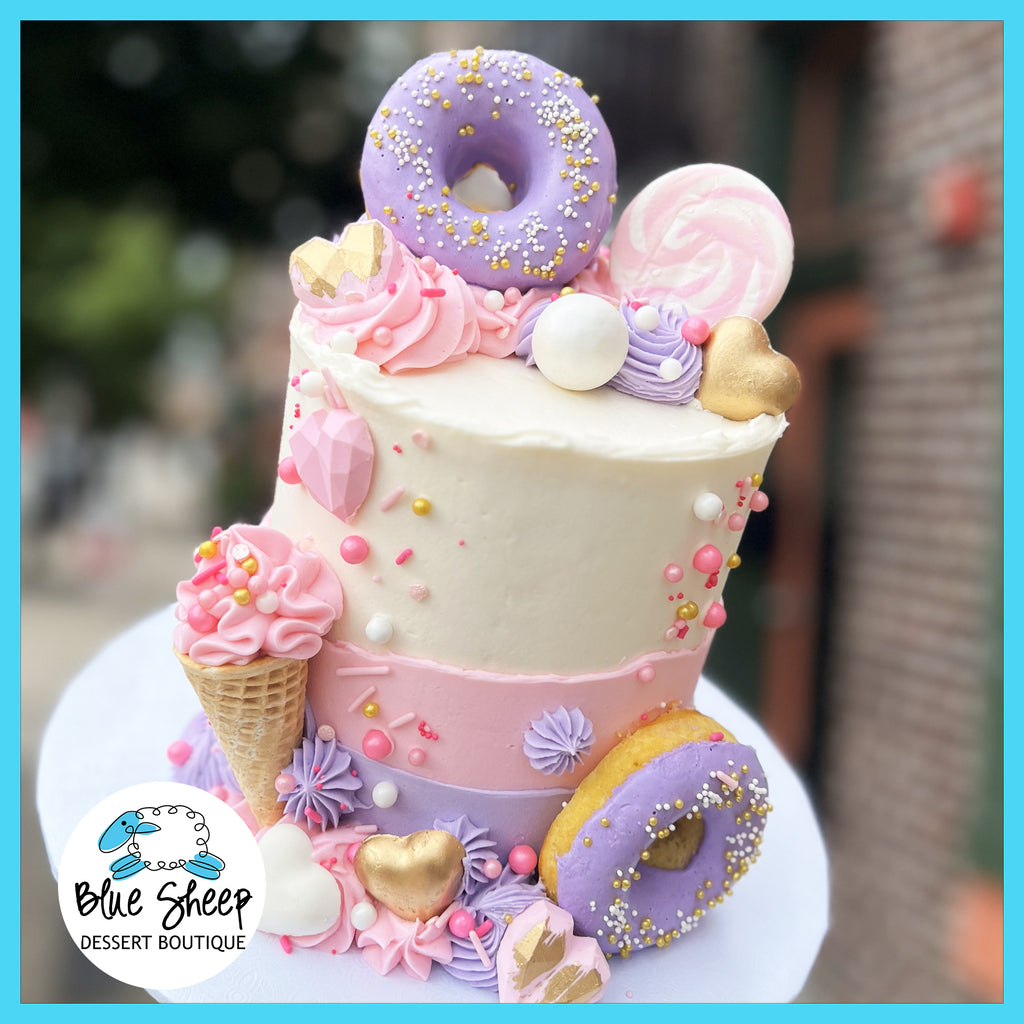 Pink and lavender buttercream birthday cake with donut 
