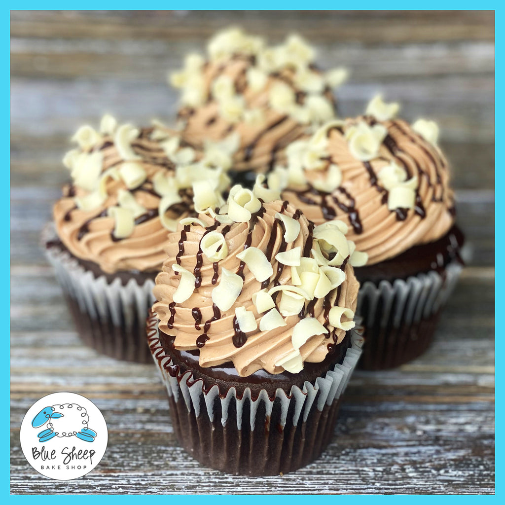 Decadent chocolate cupcakes topped with rich ganache and milk chocolate Swiss buttercream
