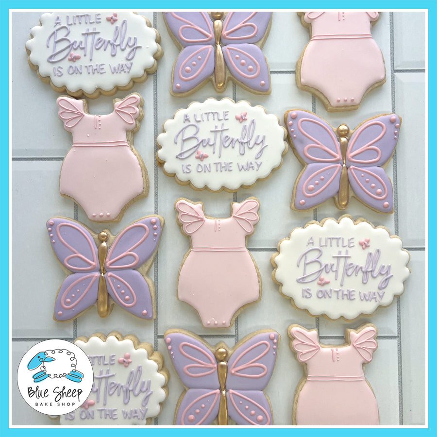 Pink and purple butterfly-themed baby shower cookies with onesie and "A Little Butterfly is on the Way" designs.