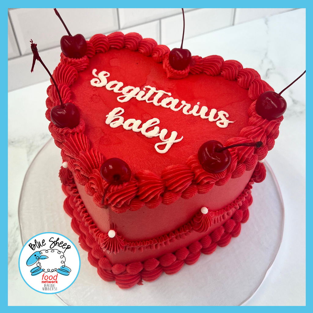 Heart-shaped birthday cake with  script astrological sign 