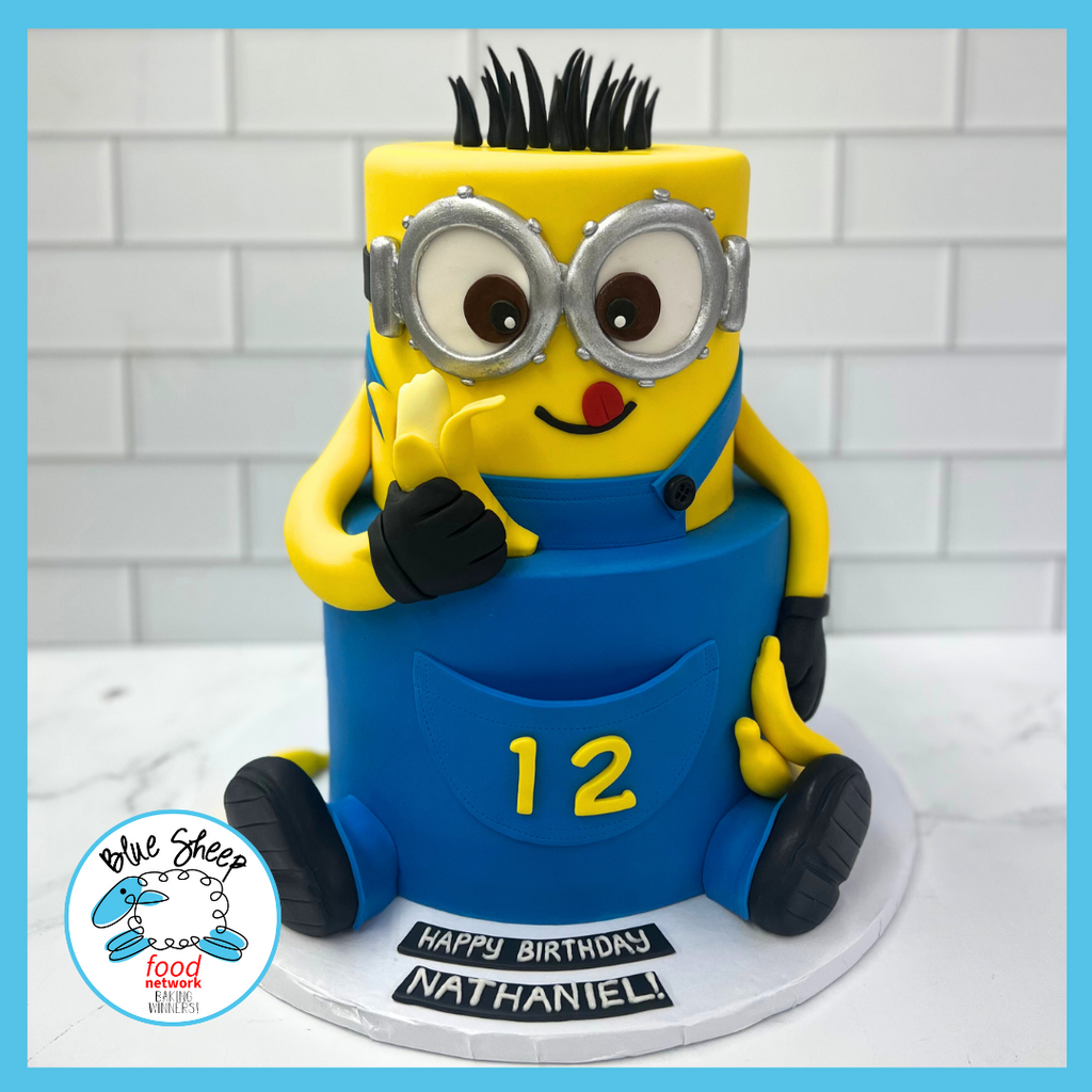Colorful minion-themed birthday cake with detailed fondant work, featuring a popular animated figure, customized with the number 12 and a birthday message.