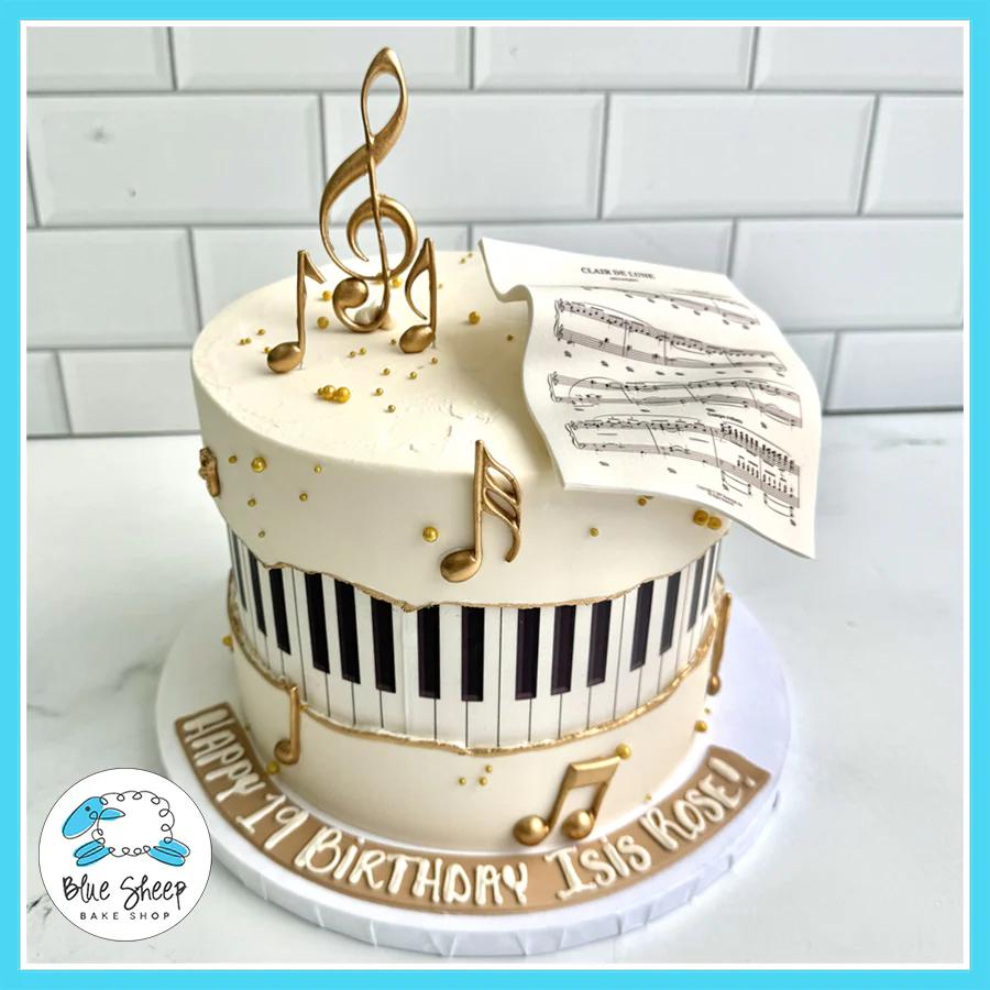 Musical Piano Birthday Cake with piano keys, golden musical notes, and a fondant music sheet, personalized with a birthday message.