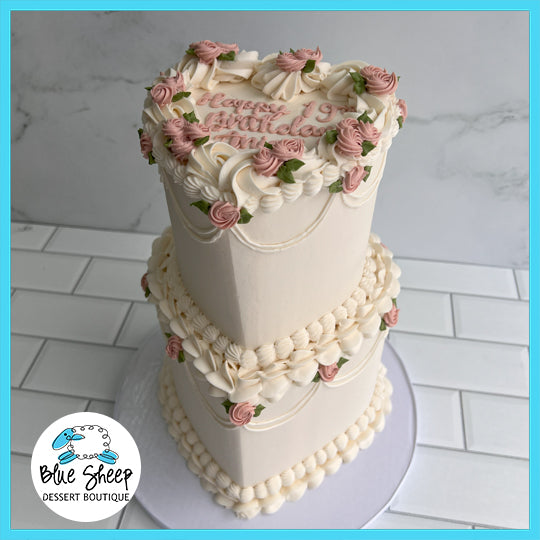 Tea Party Heart Tiered custom birthday cake with heart-shaped design, pink roses, and intricate piping details.