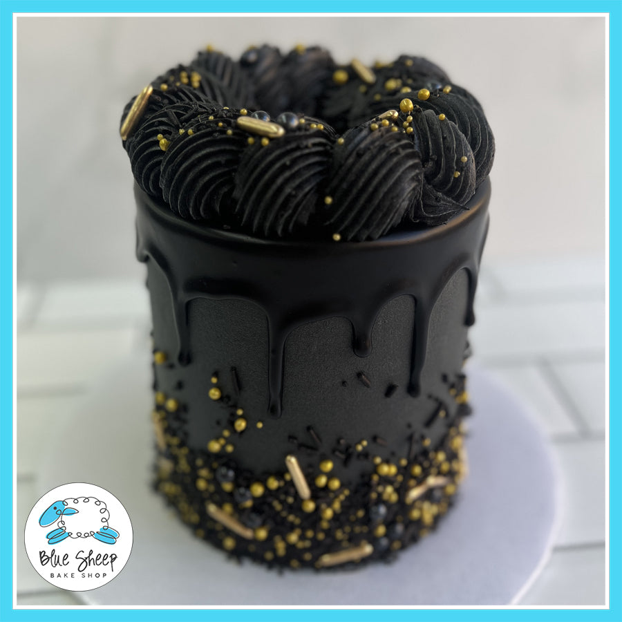 Luxury black buttercream cake with chocolate ganache drip, gold accents, and sprinkles, handcrafted by Blue Sheep Bake Shop in Somerville, NJ.

