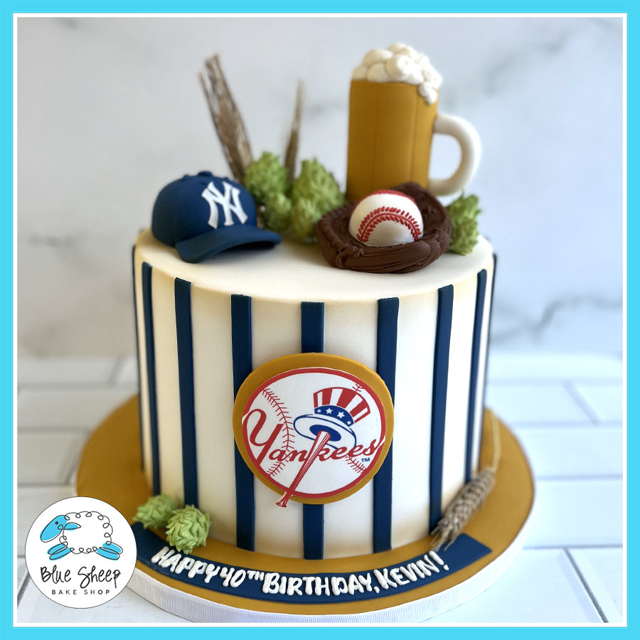 Custom NY Yankees-themed birthday cake with pinstripes, a baseball glove, hops, and a beer mug topper by Blue Sheep Bake Shop in Somerville, NJ.

