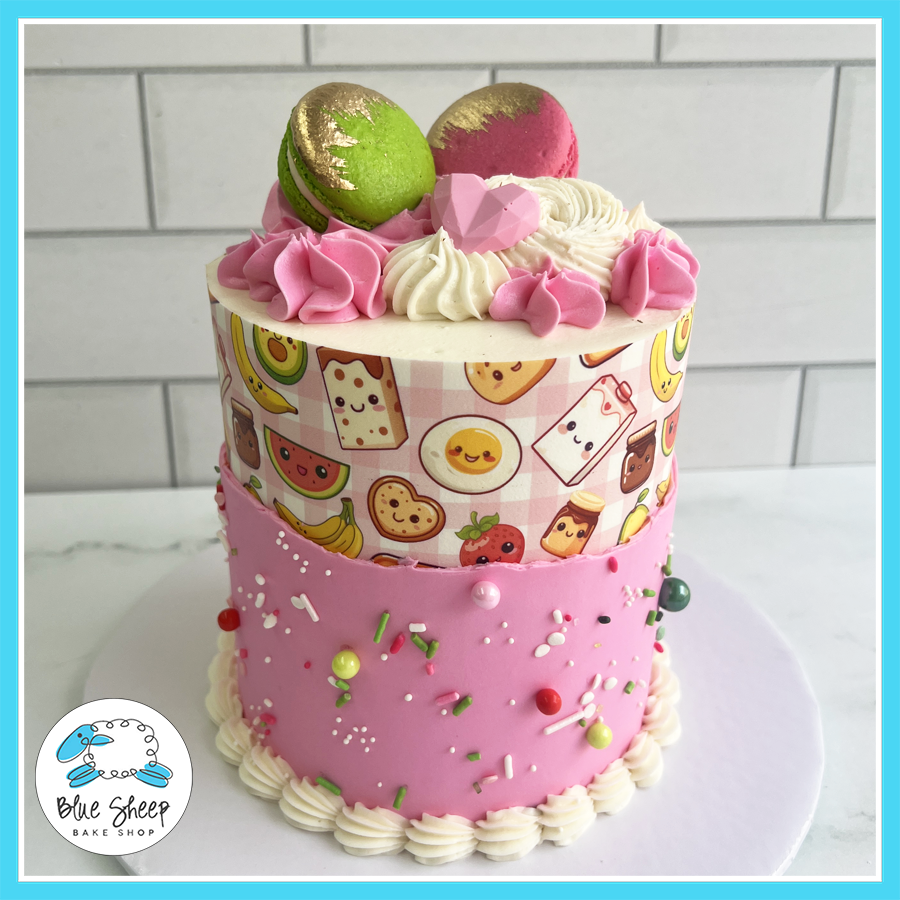 Cute kawaii snack-themed birthday cake with edible lunchbox print, pink frosting, and macarons from Blue Sheep Bake Shop in Somerville NJ