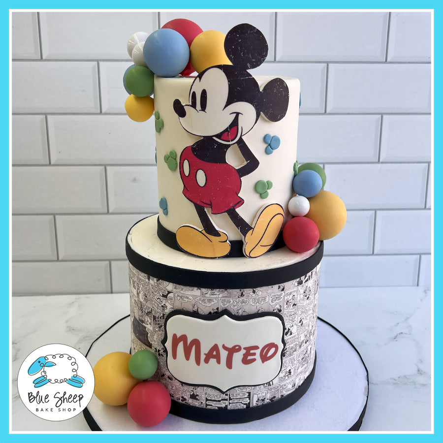 Custom Mickey Mouse birthday cake with classic Mickey design, comic strip base, and colorful balloons by Blue Sheep Bake Shop in Somerville, NJ.