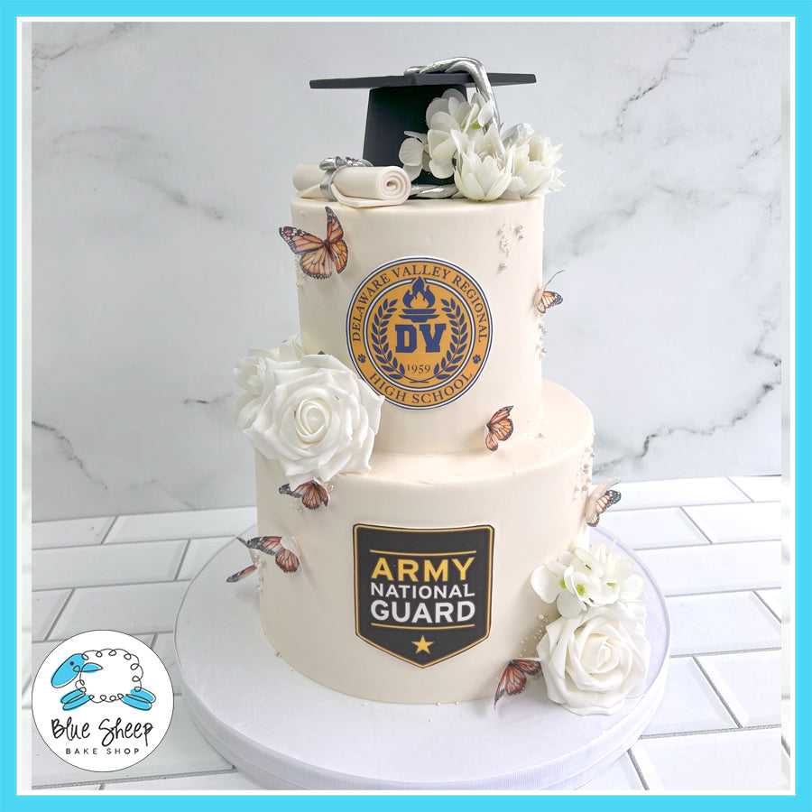 National Guard Graduation Cake with high school emblem, Army National Guard logo, white roses, butterflies, and a graduation cap topper.