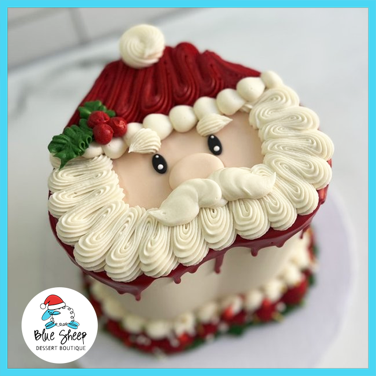 Santa Face Christmas Cake with buttercream beard, red Santa hat, and holiday decorations made by Blue Sheep Bake Shop in Somerville NJ.
