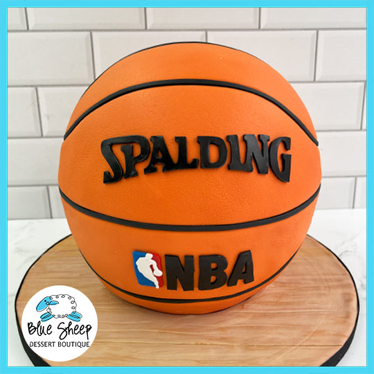 A sculpted basketball cake with detailed Spalding and NBA logos, ideal for a basketball-themed birthday.