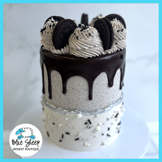 Oreo themed custom birthday cake with cookies and cream layers, chocolate drip, and Oreo cookies on top.