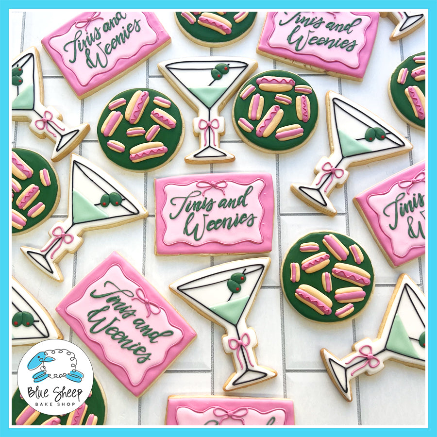 Custom "Tinis and Weenies" 21st birthday cookie favors with martini glasses, pink and green designs, and playful details by Blue Sheep Bake Shop in Somerville, NJ.