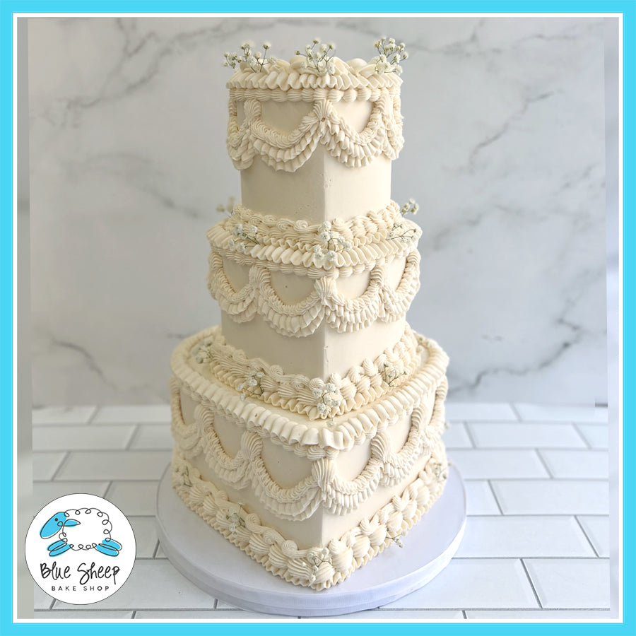 victorian style lambeth wedding cake with piped buttercream ruffles and floral accents