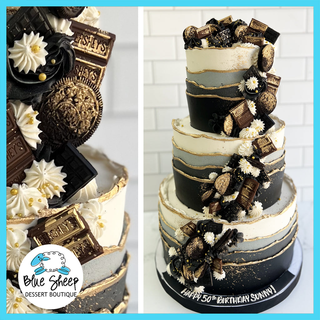 Elegant custom black and grey ombre birthday cake adorned with gold leaf, assorted premium chocolates, and personalized birthday message.