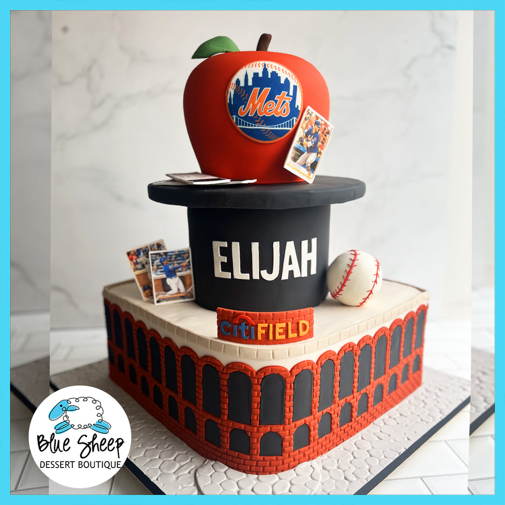 Custom baseball-themed cake designed as Citi Field stadium with a top hat, a red fondant apple featuring the New York Mets logo, a baseball, and trading card decorations, personalized with the name Elijah