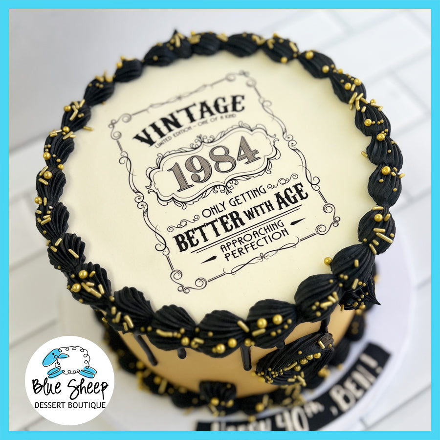 Vintage 1984 themed birthday cake with elegant black and gold design details