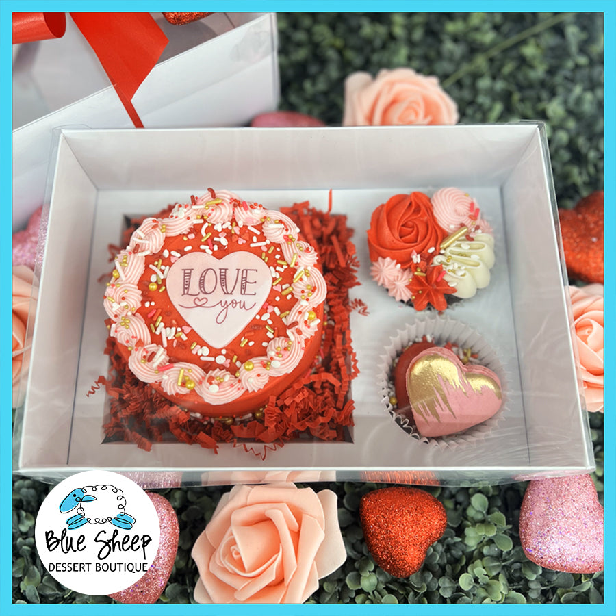 Valentine's Day themed dessert gift box containing a mini  cake, gourmet brownie, and French macarons