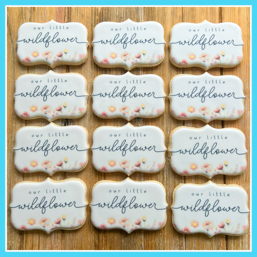 Wildflower-themed baby shower custom cookie favors with floral designs and 'Our Little Wildflower' text