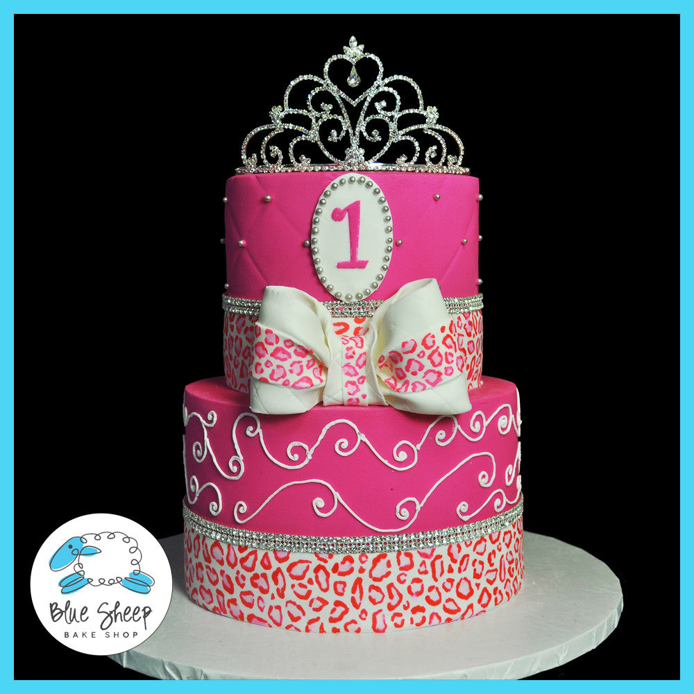 1st birthday princess cake featuring leopard print sashes and princess crown with crystal banding