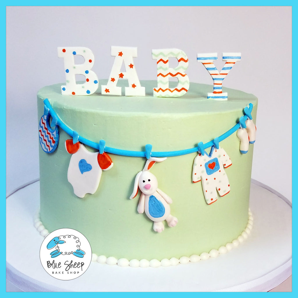 buttercream baby shower cake with clothesline