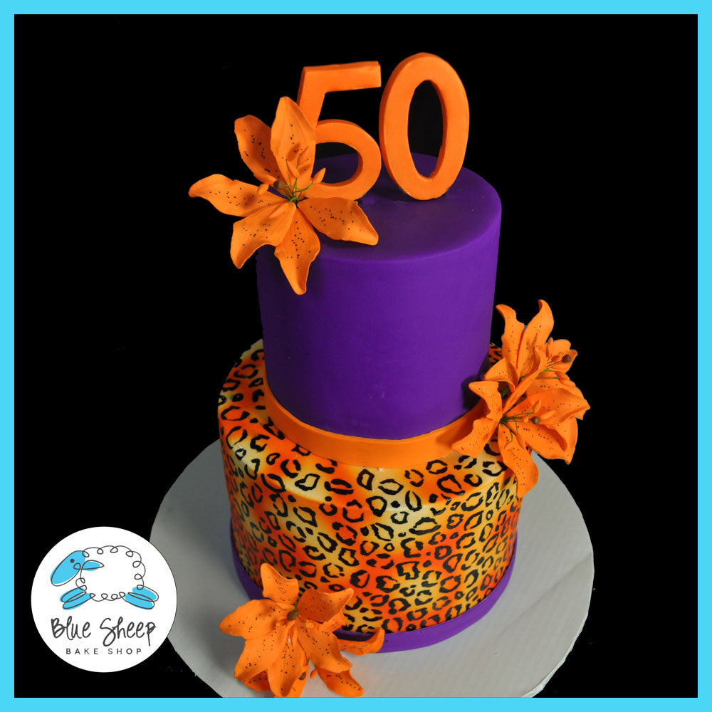 purple and orange cheetah print cake with tiger lillies