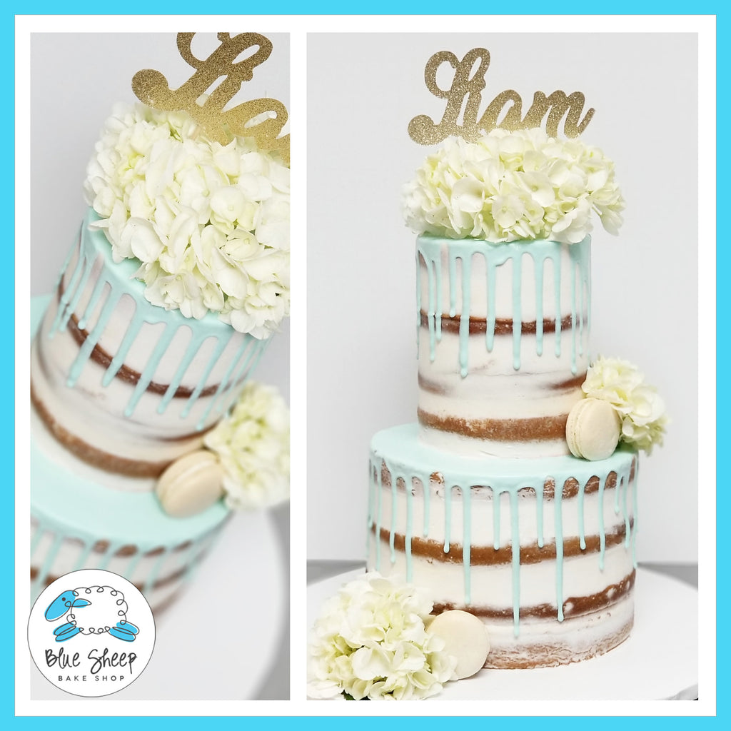 naked christening cake with blue drip fresh florals and macarons NJ