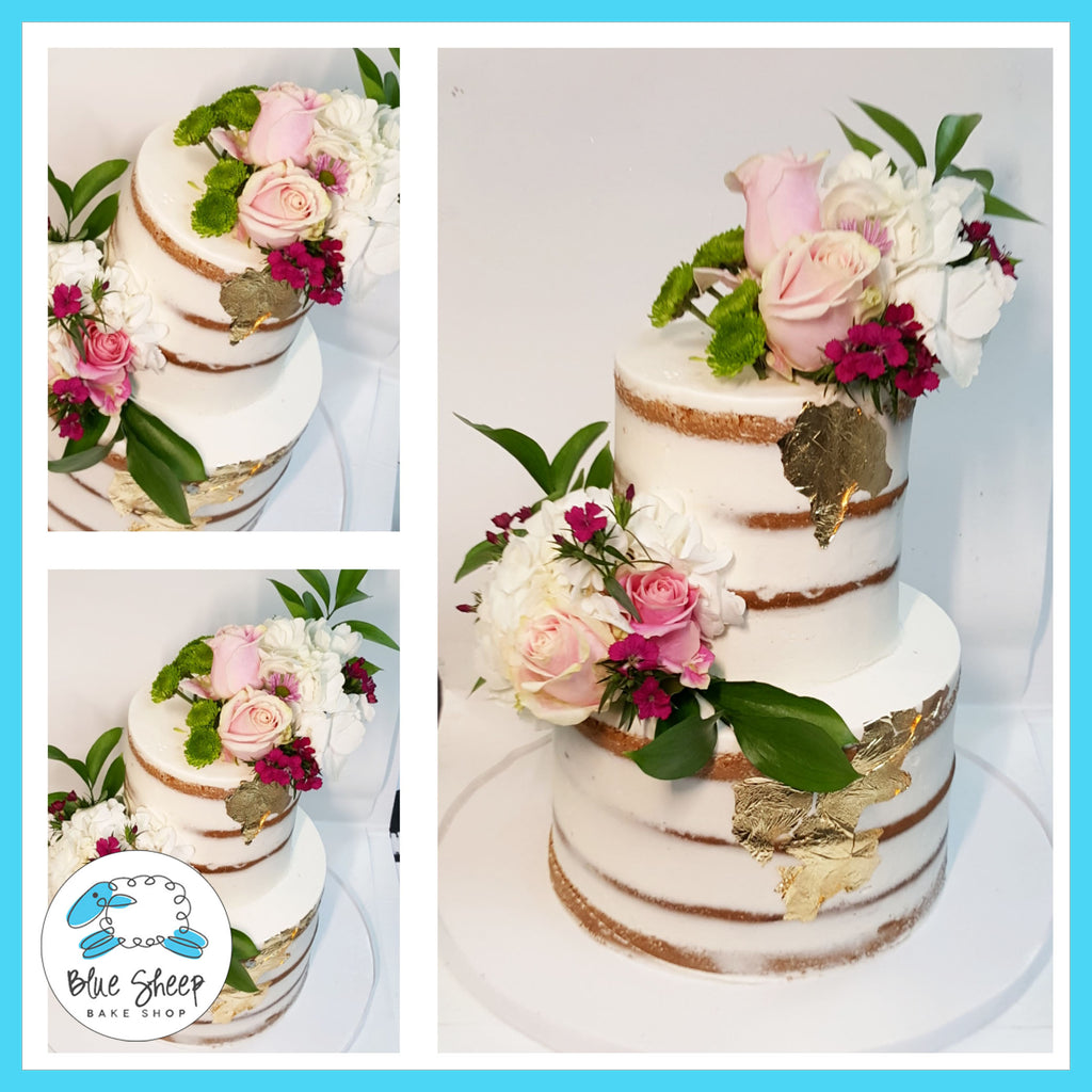 naked wedding cake with gold foil and fresh pink blooms nj