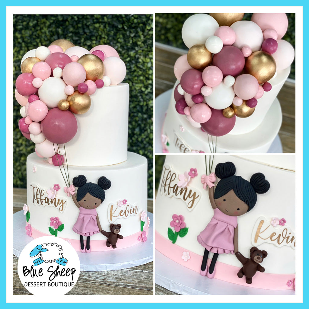 baby girl and balloons cake