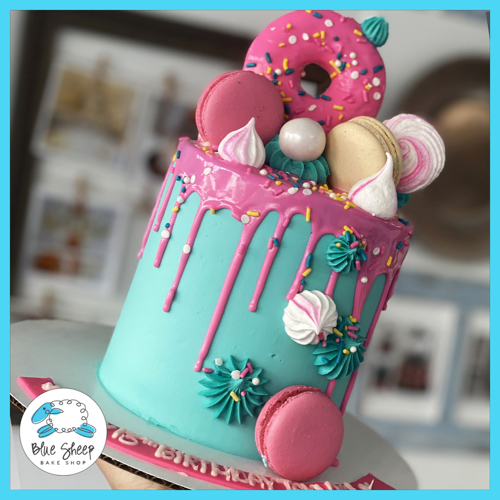pink and teal donut bakery to go cake