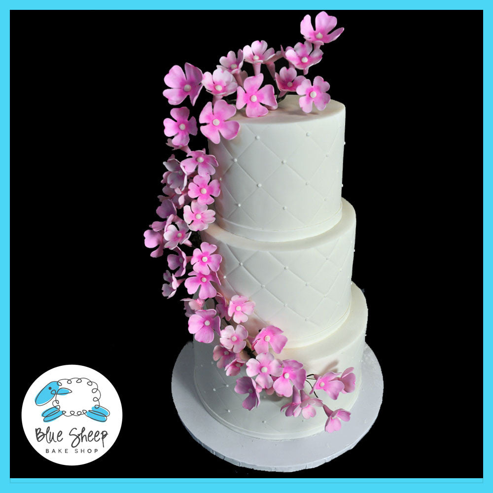 floral wedding cake with dogwood floral arrangement
