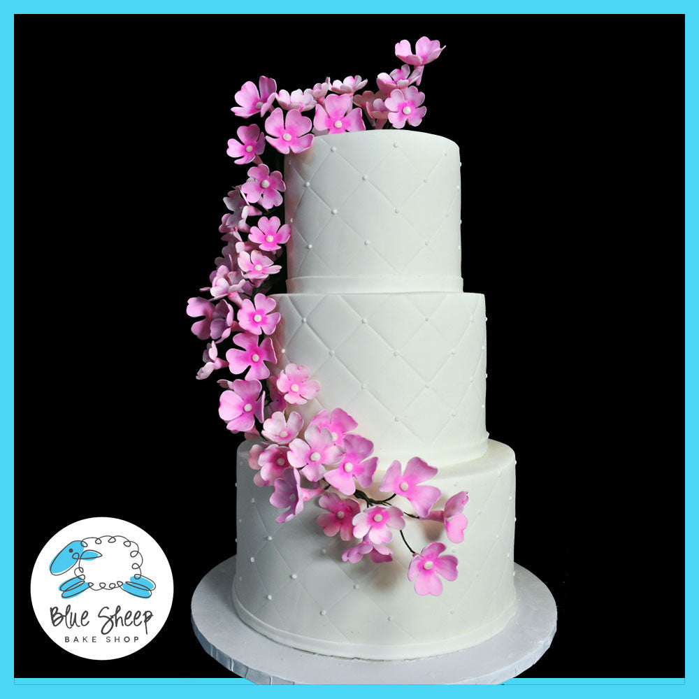 wedding cake with dogwood floral arrangement